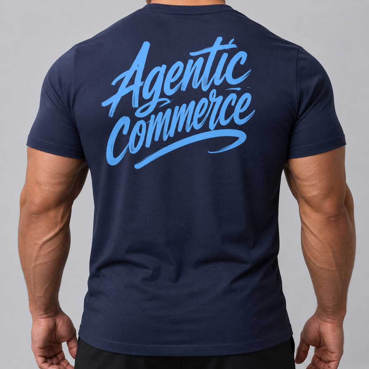 A person wears the Billboard blu tee, a comfy navy shirt with "Agentic Commerce" in bold light blue script across the back. Made from soft cotton, it's pictured from behind against a neutral background.