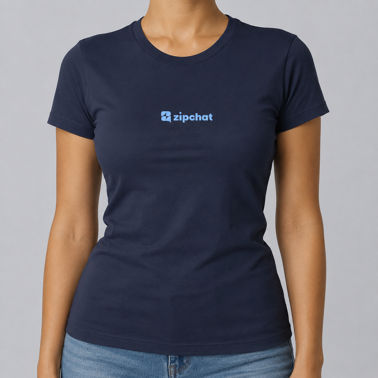 A woman wears the Billboard blu navy t-shirt, crafted from soft cotton and featuring a light blue zipchat logo and icon on the chest. She pairs it with light blue jeans against a plain gray background.